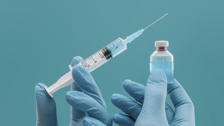 Hands holding syringe and jar medicine